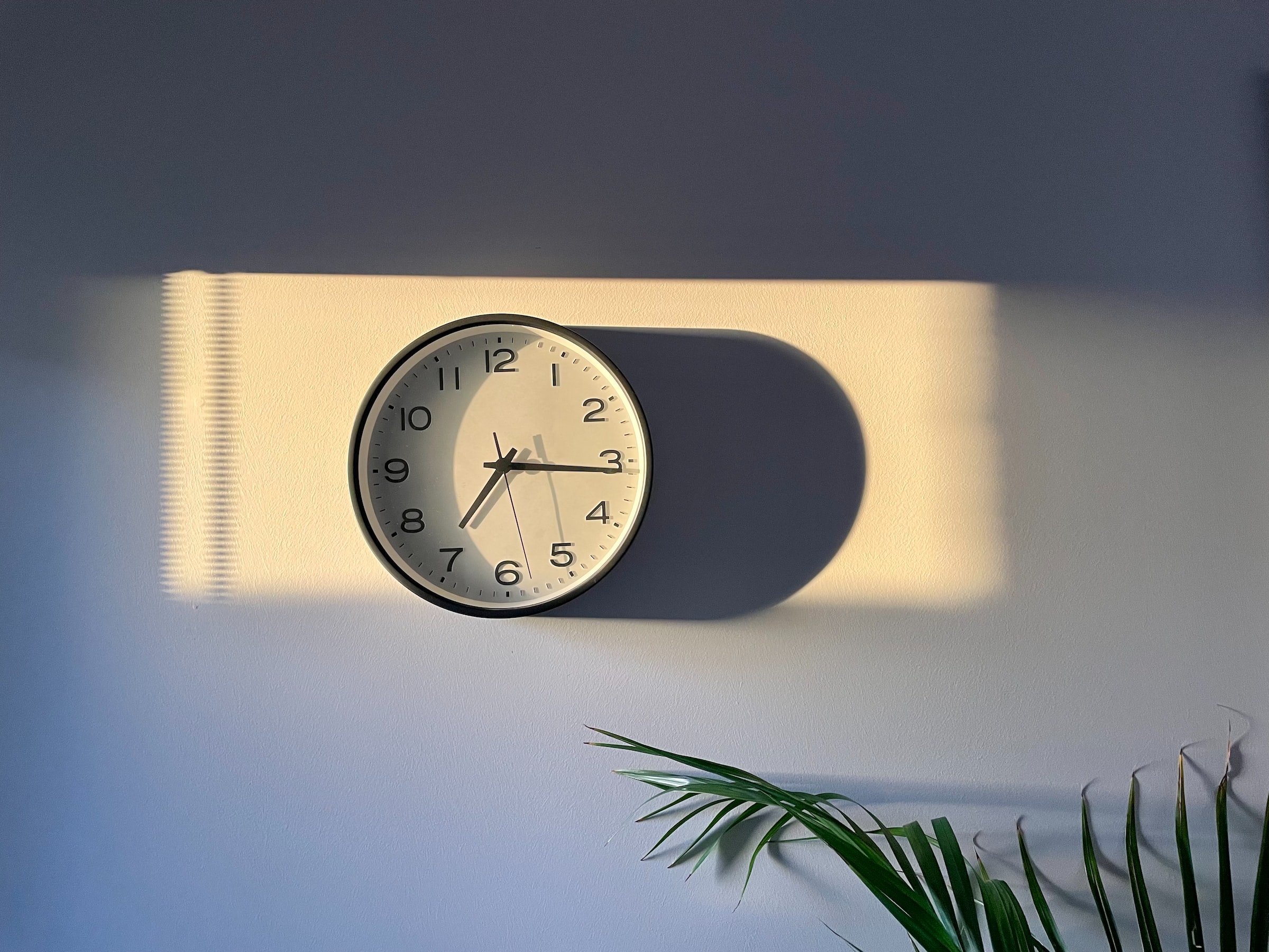 Clock on wall in sunset